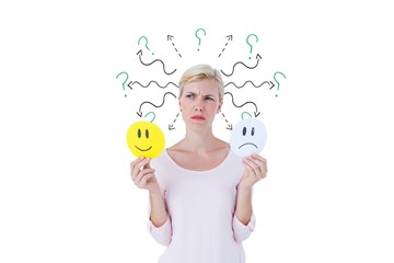 Confused woman with sad and happy emojis