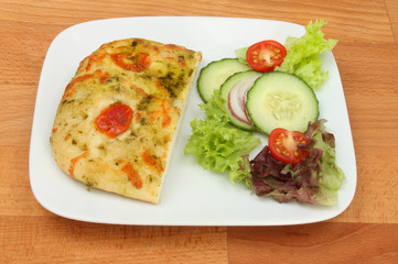 Focaccia and salad on a tabletop