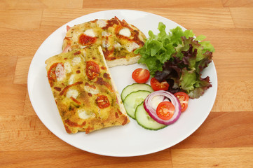 Focaccia and salad on a table