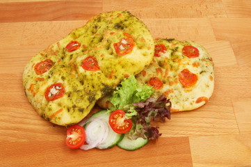 Focaccia and salad on a chopping board