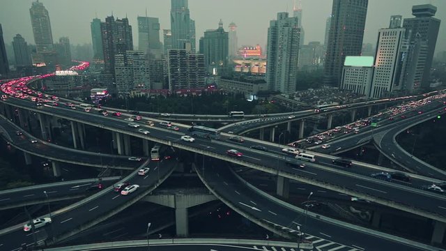 View over the famous highway intersection in Shanghai, China, with traffic. Shanghai skyline by night.