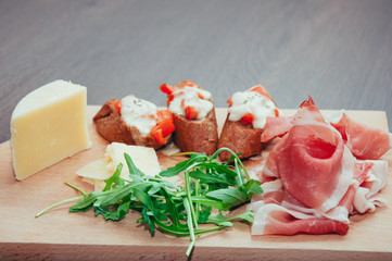 appetizer with fresh arugula,Parmesan cheese and prosciutto
