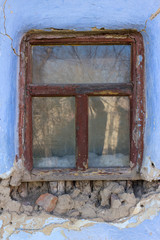 Fototapeta na wymiar window in damaged wall, needs overhaul, surface for your text.