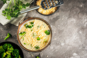 Traditional French food. quiche lorraine. Frittata. Ready for baking in the oven egg omelet with vegetables - broccoli - cheese and greens. Rustic, homemade meal. On a gray concrete table
