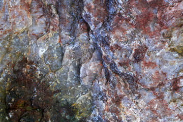 beautiful colored background with a rough texture of stone with various patches and cracks
