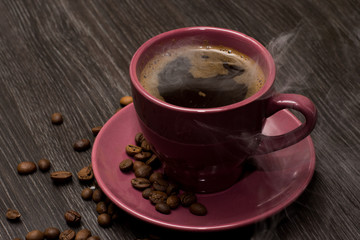 Coffee cup and coffee beans on table