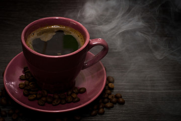 Coffee cup and coffee beans on table