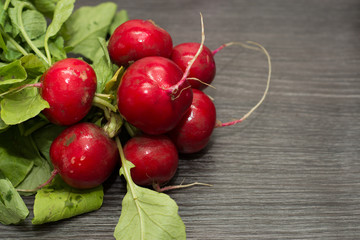 Fresh radishes on wooden table.