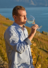 Man holding a glass of wine. Lavaux, Switzerland
