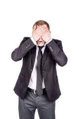 portrait young businessman covering his eyes with his hand. emotions, facial expressions, feelings, body language, signs. image on a white studio background.