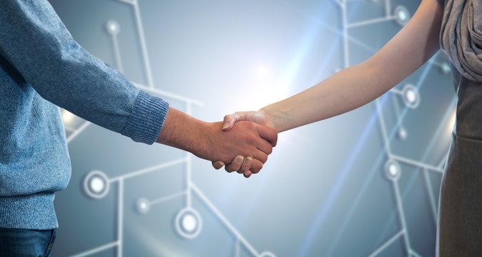Composite image of partners shaking hands