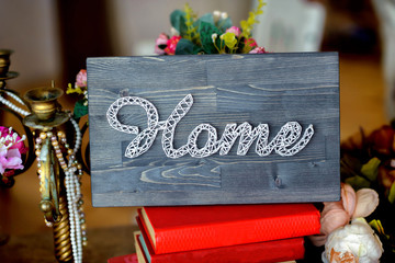 decorative inscription the home executed by threads on a board