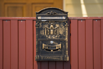 Metal mailbox on the fence.