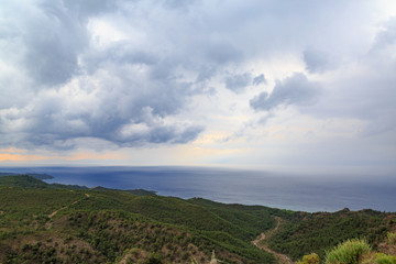 Fototapeta na wymiar Rain clouds coming to the mountain from sea