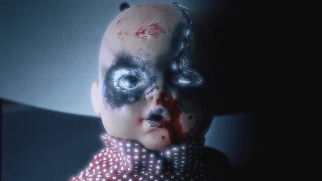 A demonic doll, looking at the viewer, moving eyes and mouth. Still shot, supernatural white glow.  Halloween horror themed clip.
