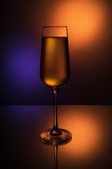 Glass Goblets on a colored background with color liquid and with reflection