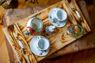 tray with two circles for tea, and a fresh branch of a mountain ash