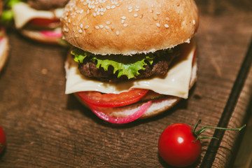 Burger and small tomatoes on a blackboard