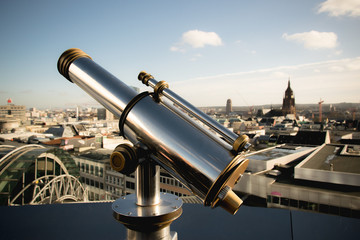 Glänzendes Fernrohr auf Aussichtspunkt mit Blick auf Frankfurt am Main, Deutschland