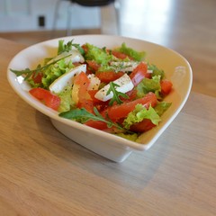 Bowl with Italian caprese salad with lettuce, mozzarella  and tomato