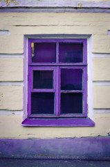 Fototapeta premium Window with purple frame on beige wall