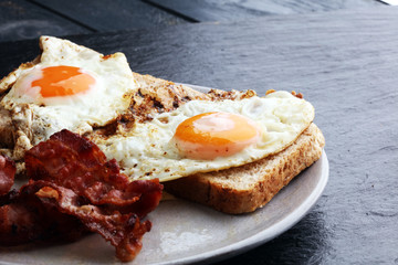 Ham and Egg. Bacon and Egg. Salted egg and sprinkled with black pepper. English breakfast.