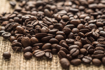 Coffee beans on sacking background