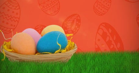 Composite image of colorful easter eggs in wicker basket 