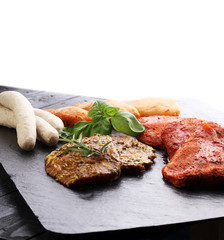 Selection of marinaded meat for grilling and sausages
