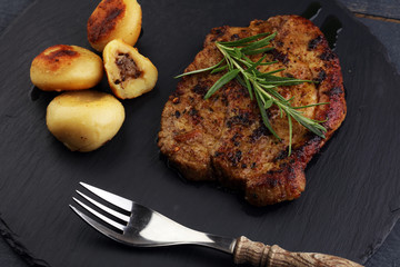 Grilled steaks, baked dumplings potatoes