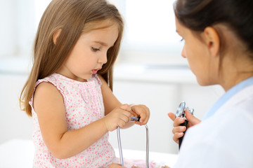 Happy little girl at  health exam at doctor office. Medicine and health care concept