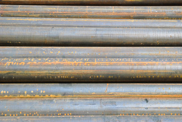 Metal pipes, stacked in a pile. Background, texture