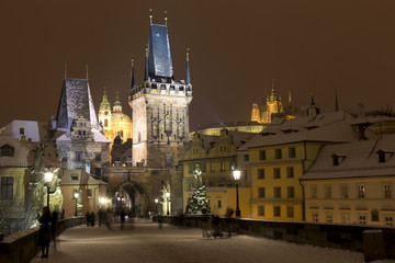 Night snowy Prague Lesser Town with Bridge Tower and St. Nicholas' Cathedral from Charles Bridge, Czech republic