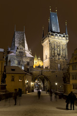 Naklejka na ściany i meble Night snowy Prague Lesser Town with St. Nicholas' Cathedral and Charles Bridge, Czech republic