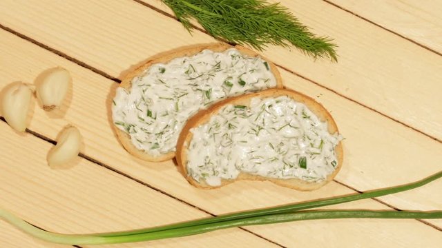 A sandwich with garlic sauce on wooden background