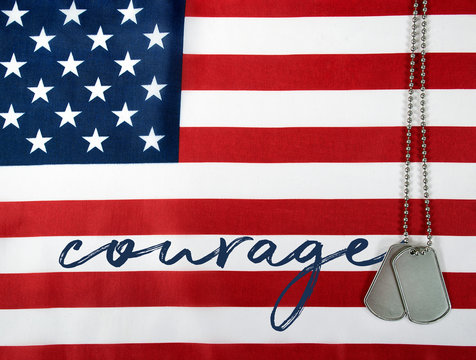 word courage and military dog tags on American flag
