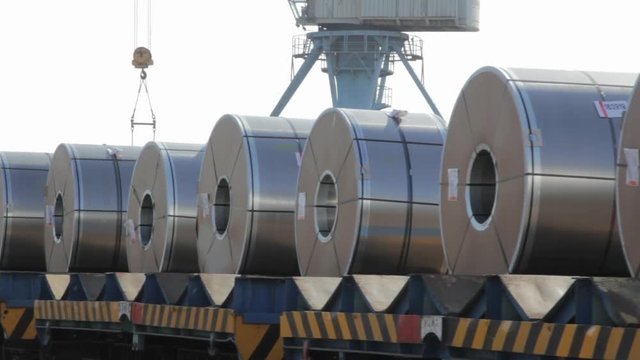 Train loaded with steel coils arriving at port