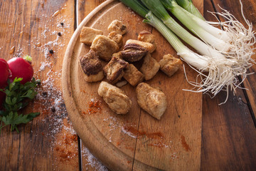 roasted pork greaves  on wooden background