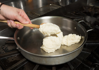 Preparing solid cheese in a pan, for Macaroni cheese