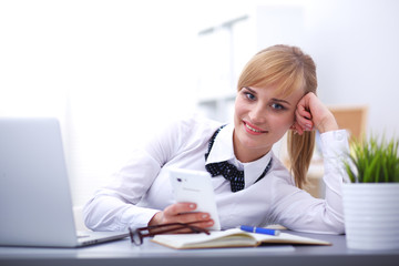 Woman in office using mobile phone