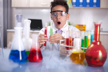 little schoolboy working in chemistry lab