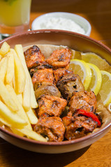Delicious grilled chicken kebab ,marinated in spices, served with fries, lemon wedges, mushroom and tahini sauce.