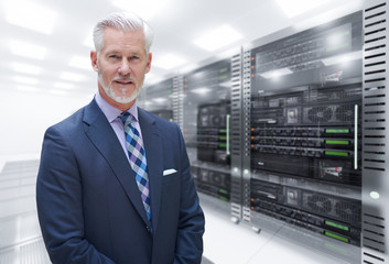 Senior businessman in server room