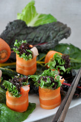 Fototapeta na wymiar Carrot Rolls with Green Veggie on Background