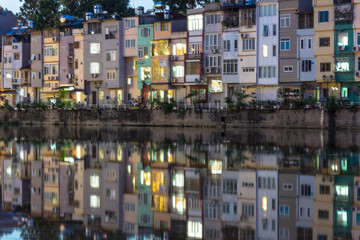Resident houses with reflection on lake in Hanoi, Vietnam