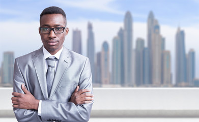Young black businessman in front of the big city