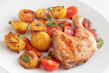 roast of chicken and vegetables with fresh cherry tomatoes, cilantro, and pumpkin seeds