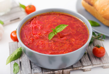 Traditional Ukrainian Russian vegetable borscht soup  on blue bowl.