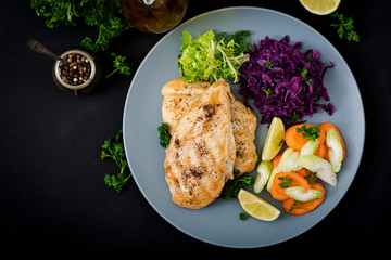 Chicken breast cooked on a grill with vegetables. Flat lay. Top view
