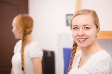 Happy woman reflecting in mirror